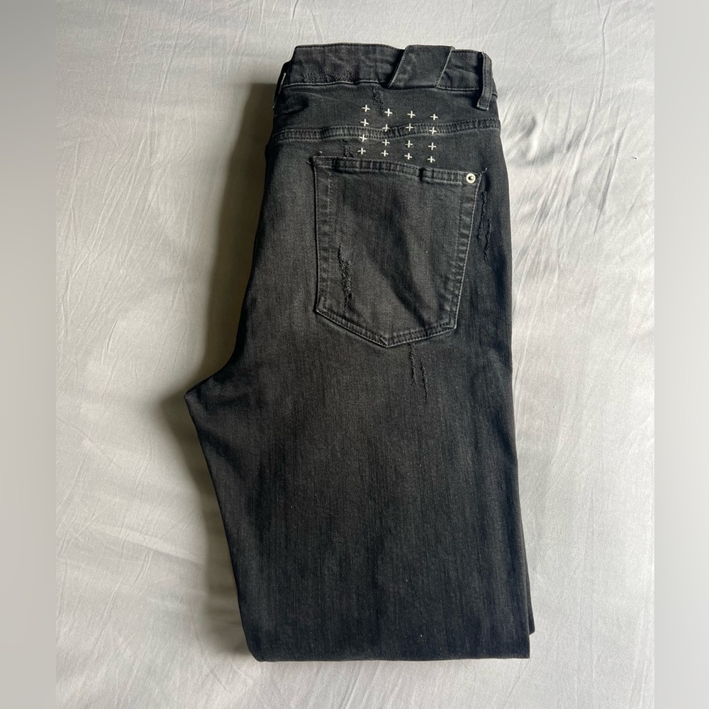 Men’s designer black jeans by KSUBI.